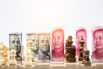 Wall Mural - US dollar and Yuan banknote with chess for tariff trade war between United States and China which both countries battle by increase tax barrier of import and export product. Government and business.