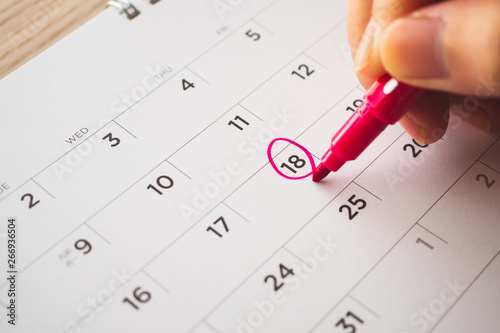 Fotografía Female Hand with pen mark on calendar date