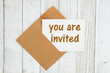 You are invited text on a greeting card with envelope