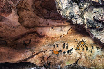 Drawing of an ancient Stone Age man in a cave. Prehistoric painting. 