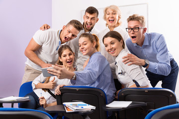 Wall Mural - Students with female teacher making selfie indoors