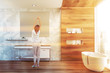 © ImageFlow - Woman stretching in wooden bathroom