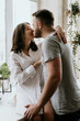 © malysheva - Romantic young couple cooking together in the kitchen,having a great time together.
