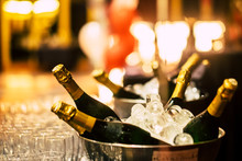 Night Event Party Celebration Concept With Fluts Glasses And Wine Champagne Bottles Ready To Be Drinked From People - Bokeh Defoused Light Background