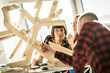 © Westend61 - Group of creative professionals building wood object for a project