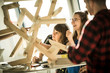 © Westend61 - Group of creative professionals building wood object for a project
