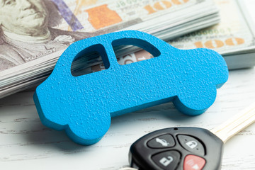 Canvas Print - Car and keys with alarm on the background of a stack of cash money dollars