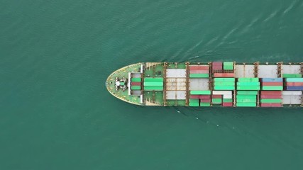 Wall Mural - Video Container ship in export and import business logistics and transportation. Cargo and container box shipping to harbor by crane. Water transport International. Aerial view and top view.
