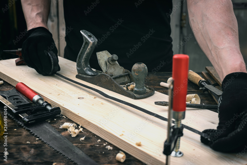 Work Measurement Meter Worker is take a measurements with a construction meter of a wooden bar ...