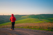 © Alvaro Sanchez/ADDICTIVE STOCK - Back view of man in jacket walking on empty rural road in majestic green fields of Italy