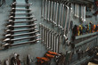 © Fabio Purroy/ADDICTIVE STOCK - Set of assorted repair tools attached to grungy metal wall in professional workshop
