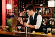 © Manuel Ruiz Alba/ADDICTIVE STOCK - Young elegant barman working behind a bar counter mixing drinks with fruits