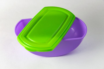 eco-friendly lilac plastic food storage container, color lid, on white