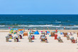 Unrecognisable people relax on a Baltic sea beach on Usedom island in Swinoujscie city, Poland