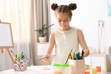 Poster - Little girl painting picture at table indoors