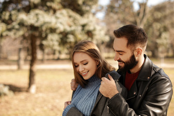 Wall Mural - Portrait of cute young couple in park on sunny day