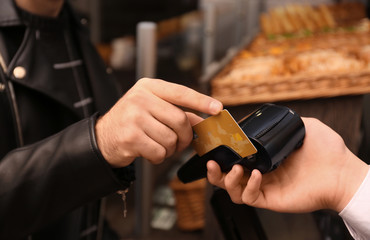 Sticker - Man with credit card using payment terminal at shop, closeup