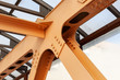 Heavy Beams And Chanals Of Steel Bridge Construction Painted Orange Paint. Metal Framework Of Structure Closeup.