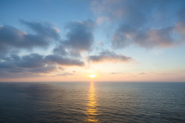 Wall Mural - beautiful sunset over sea , majestic clouds in the sky .