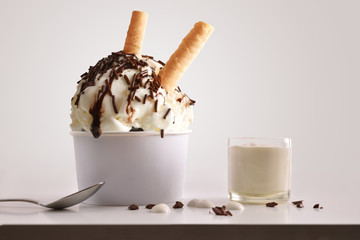 Composition of ice cream and choco ball in paper cup