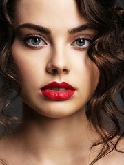 Poster - Face of a beautiful woman with a smoky eye makeup and red lipstick