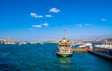 Muslim architecture and water transport in Turkey - Beautiful View touristic landmarks from sea voyage on Bosphorus. Cityscape of Istanbul at sunset - old mosque and turkish steamboats, view on Golden