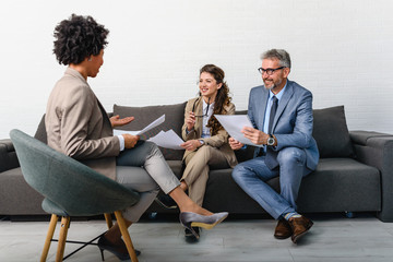 Wall Mural - Business people having informal meeting in office. Diverse team discussing work.