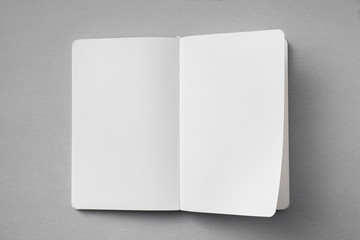 white notebook with turn page on grey background