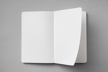 white notebook with turn page on grey background