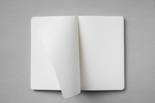 White Notebook With Turn Page On Grey Background