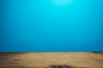 Fototapete - Beautiful brown wooden table and blue wall background.