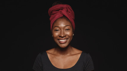 portrait of smiling african woman in a headwrap