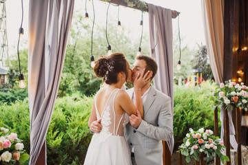 Beautiful wedding couple. The bride and groom are standing at the wedding ceremony. The bride in a beautiful dress тhe groom is dressed stylishly