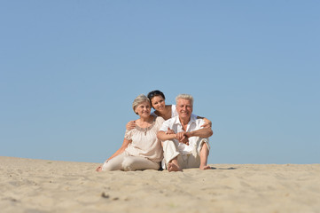 Canvas Print - Portrait of people sitting on the sand