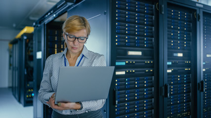 Aufkleber - Portrait Shot In Data Center: Female IT Technician Running Maintenance Programme on a Laptop, Controls Operational Server Rack Optimal Functioning. Modern High-Tech Telecommunications Data Center.