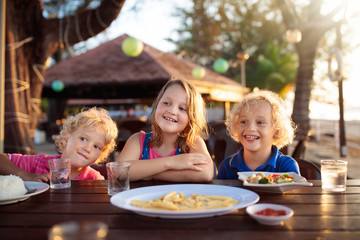 Family vacation lunch. Kids in beach restaurant