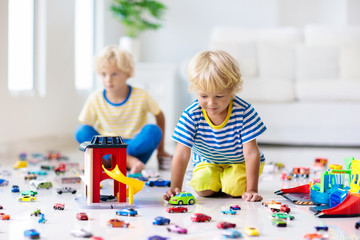 Kids play with toy cars. Children playing car toys