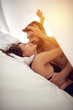 Couple in love having intimate sex in bed.