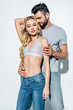 © LIGHTFIELD STUDIOS - handsome man with closed eyes touching attractive blonde girl in lace bra on white