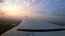 4K, Beautiful Aerial View Of A Taiwan With A Sunset. Twilight And Wing Of The Plane As Seen Through An Airplane Window During The Flight. Passenger POV Traveling By Air. Aircraft During The Trip.-Dan