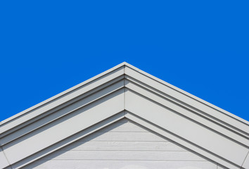 Poster - modern gable roof design house facade wall with clear blue sky background.