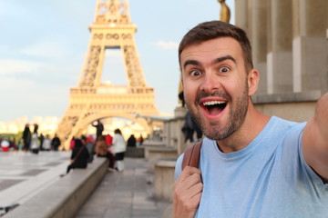 Wall Mural - Excited man taking a selfie in the Eiffel Tower, Paris