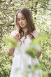 © Iveta - Young beautiful girl stay in apple blossom garden