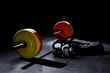 Bumper plates in gym with dramatic lighting