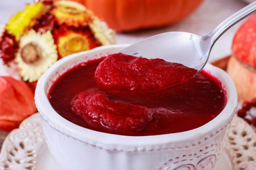 Poster - Creamy autumn soup in white plate. Seasonal pumpkin decorations