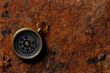 Magnetic compass on rough rusty background