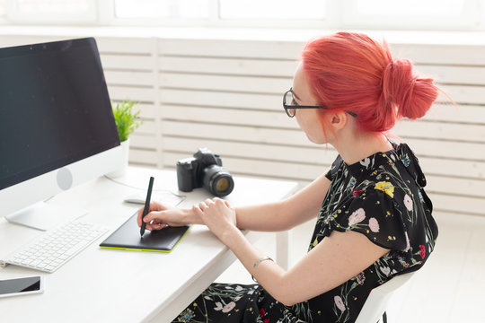Graphic designer, people concept - Young designer female hipster with graphic tablet working in office