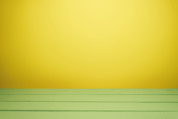 Fototapete - Beautiful olive wooden table and yellow wall background.