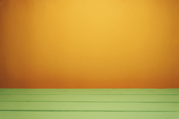 Fototapete - Beautiful olive wooden table and orange wall background.