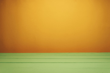 Fototapete - Beautiful olive wooden table and orange wall background.